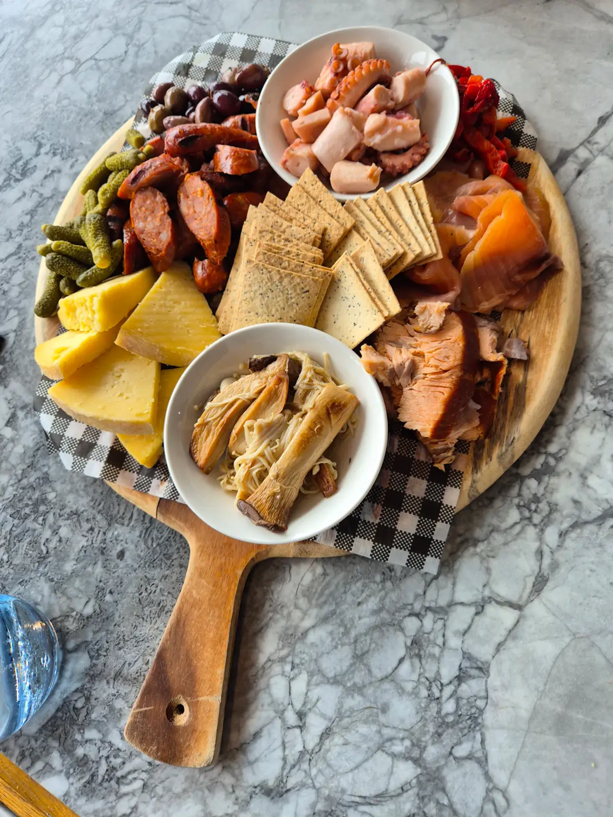 A wooden platter filled with different types of food